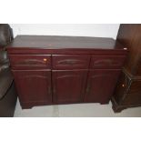 A modern laminate side board with three drawers and under cupboards