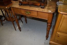 An ecclesiastical style hall or side table having pine top with turned pitch pine legs