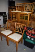 A set of four mid century bent wood beech framed chairs with vinyl seats