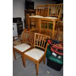 A set of four mid century bent wood beech framed chairs with vinyl seats