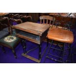 An early 20th Century school desk and chair, oak and cast iron frame