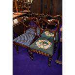 A set of four Victorian balloon back dining chairs