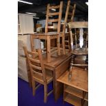 A modern pine full length drop leaf table and set of four solid seat ladderback chairs