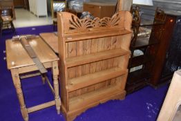 A natural pine bookshelf with fretwork to back, width approx. 82cm
