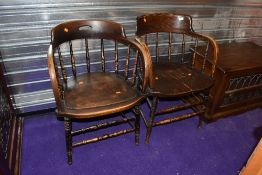 Two captains style dark stained spindle back chairs