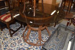 A mid century style steam bent wood and smoked glass topped dinner table H72cm x 107cm accross