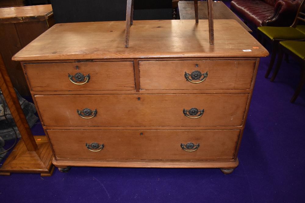 A Victorian stripped pine chest of two over two drawers having brass drop handles, dimensions