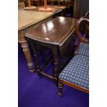 A traditional oak gate leg dining table