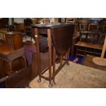 An early 20th Century mahogany narrow gateleg table on cabriole legs