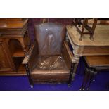 An early 20th Century oak framed armchair with leather upholstery (restoration project)