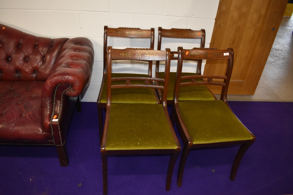 A set of four reproduction Regency rail back dining chairs having inlay to top rails, dralon seats