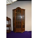 An early to mid 20th Century oak display cabinet, having glazed centre and side panels, single