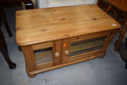 A small television stand or side cupboard in pine