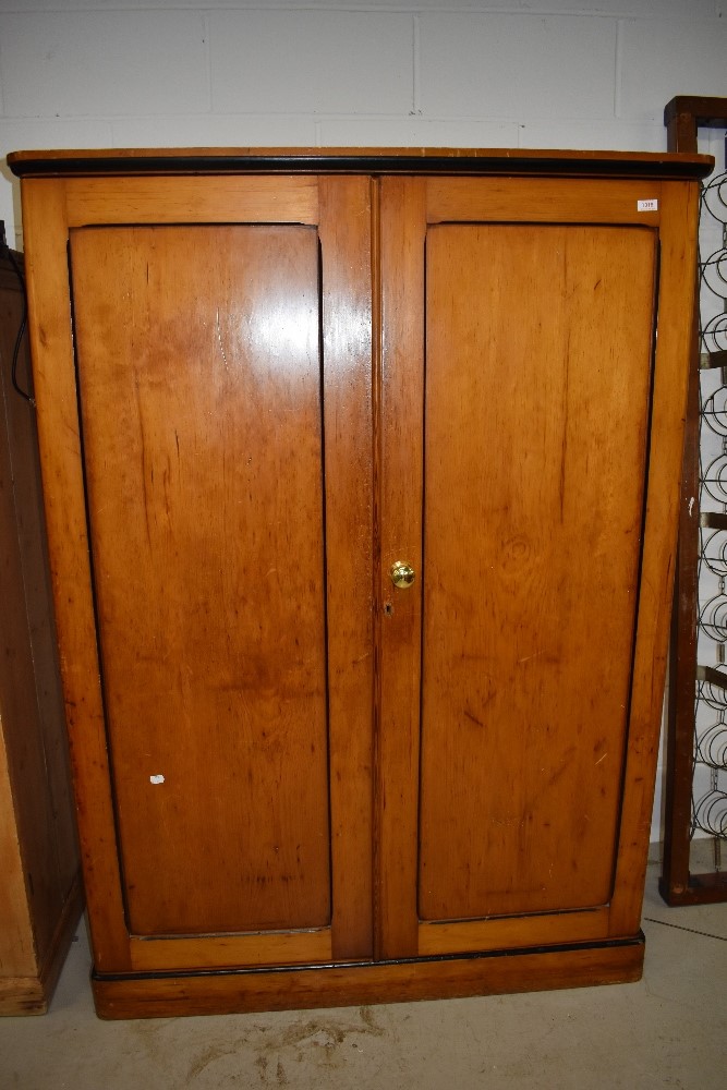 A late Victorian/Edwardian pine double wardrobe having drawer set to base good simple design