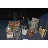 A selection of pharmacy and similar medical bottles and packaging including old labels and etched
