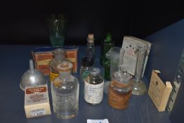 A selection of pharmacy and similar medical bottles and packaging including old labels and etched