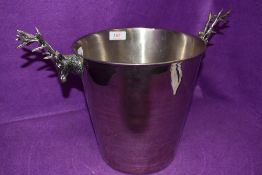 A large ice or champagne bucket having twin stag head handles