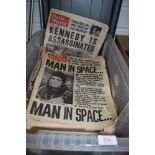 A box full of vintage newspapers.