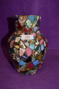 A studio pottery mosaic style vase