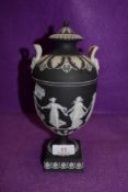 A Jasper ware Black and white basalt lidded urn and cover depicting dancing maids by Wedgwood fine