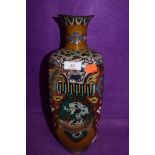 An oriental cloisonne vase having pheonic and dragon decoration having one side badly damaged