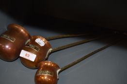 A set of graduated spirit ladle including Whiskey Brandy and Rum