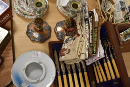 A selection of table wares including candle stick pair ash tray and HM silver cuffed cutlery set