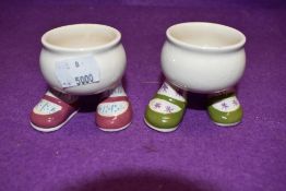 A pair of Carelton ware walking leg Egg cups in green and pink colour ways