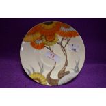 An art deco tea saucer or plate by Clarice Cliff hand decorated with orange daisy stamped Bizarre