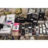 A selection of mobile phones and similar portable electronics including Sony Walkman and Tom Toms