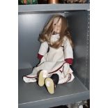 A modern ceramic limbed doll stamped made in England to neck base