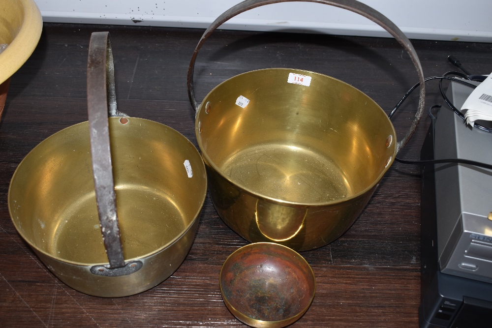 Two brass cast jam pans having iron handles with similar small brass sacriment or offering bowl