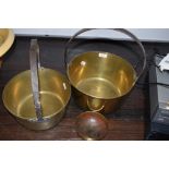 Two brass cast jam pans having iron handles with similar small brass sacriment or offering bowl