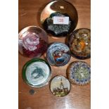 A selection of glass art paper weights including CG and Caithness Cauldron