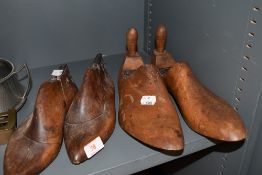 Two pairs of antique shoe forms both have tactile appealing patinas and unusual designs
