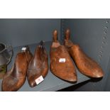 Two pairs of antique shoe forms both have tactile appealing patinas and unusual designs