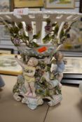 An impressive table centre fruit bowl by Meissen porcelain having cherub figures amongst foliage