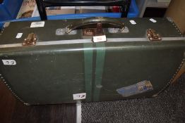 A hard bodied and metal edged travel suitcase