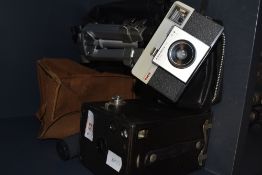 A vintage box camera, a Kodak instamatic 25 and a Velbon tripod.