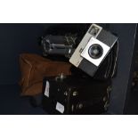 A vintage box camera, a Kodak instamatic 25 and a Velbon tripod.