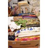 A collection of ladies scarves, vintage gloves, dress patterns and other textiles.