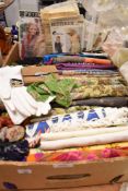 A collection of ladies scarves, vintage gloves, dress patterns and other textiles.