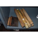 A selection of wooden farm house hand turned rolling pins and two herb chopping knives