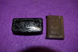 A Victorian papier mache white metal inlayed snuff box and similar pressed vesta case