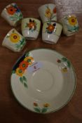 A selection of Clarice Cliff style ceramics hand painted with flowers including siz egg cups and one