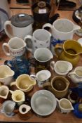 A selection of water and similar ceramic jugs including Denby coffee pot