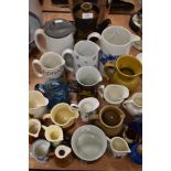 A selection of water and similar ceramic jugs including Denby coffee pot