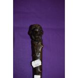 An antique walking stick hand carved in a hard wood with Monk head Character style handle in the