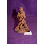 An Italian terracotta figure by Catania Grasso of a pipe smoking fisherman