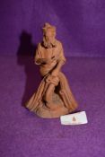 An Italian terracotta figure by Catania Grasso of a pipe smoking fisherman